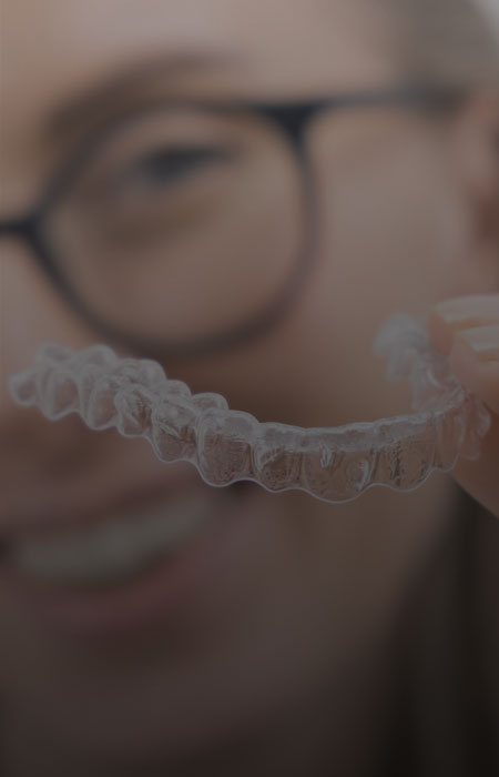 Image showing a lady holding tranparent braces