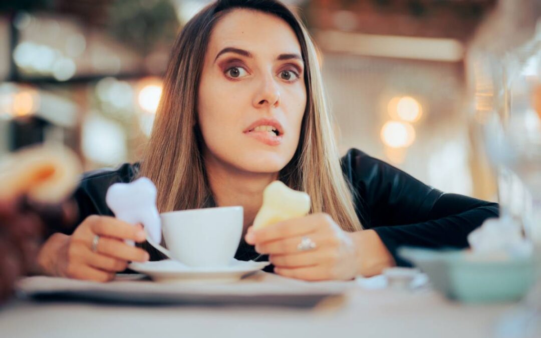 woman considering foods and drinks that stain teeth at a meal